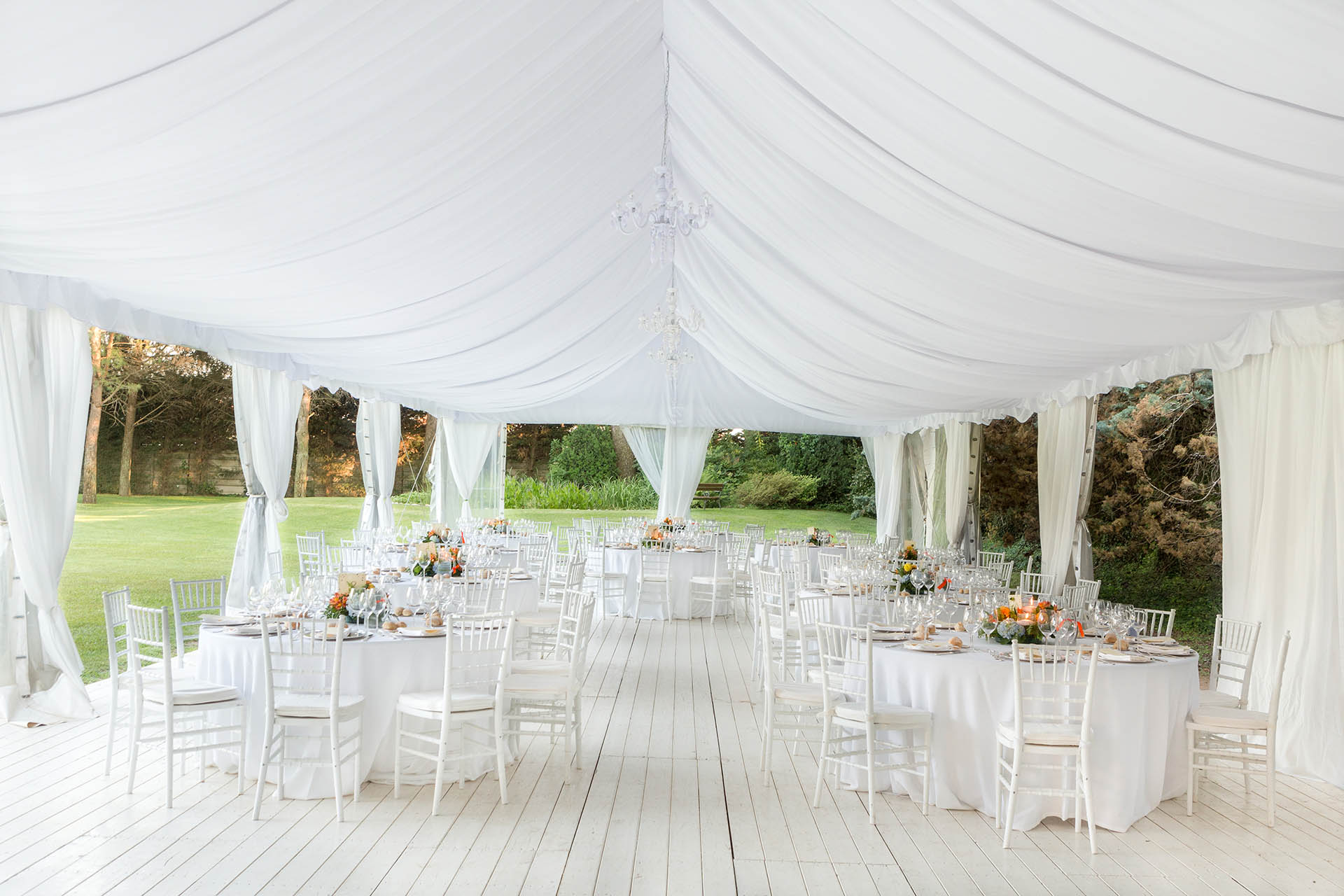 White wedding furniture and tables under tent